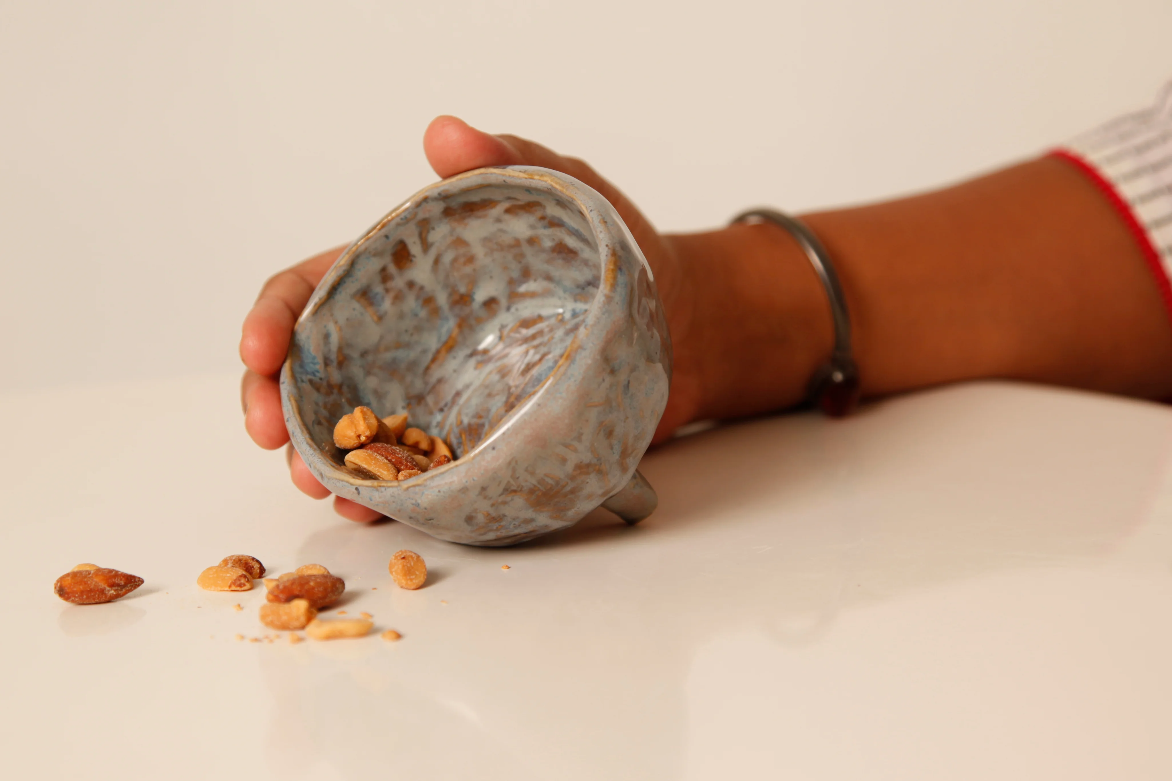 Handmade clay bowl with almonds