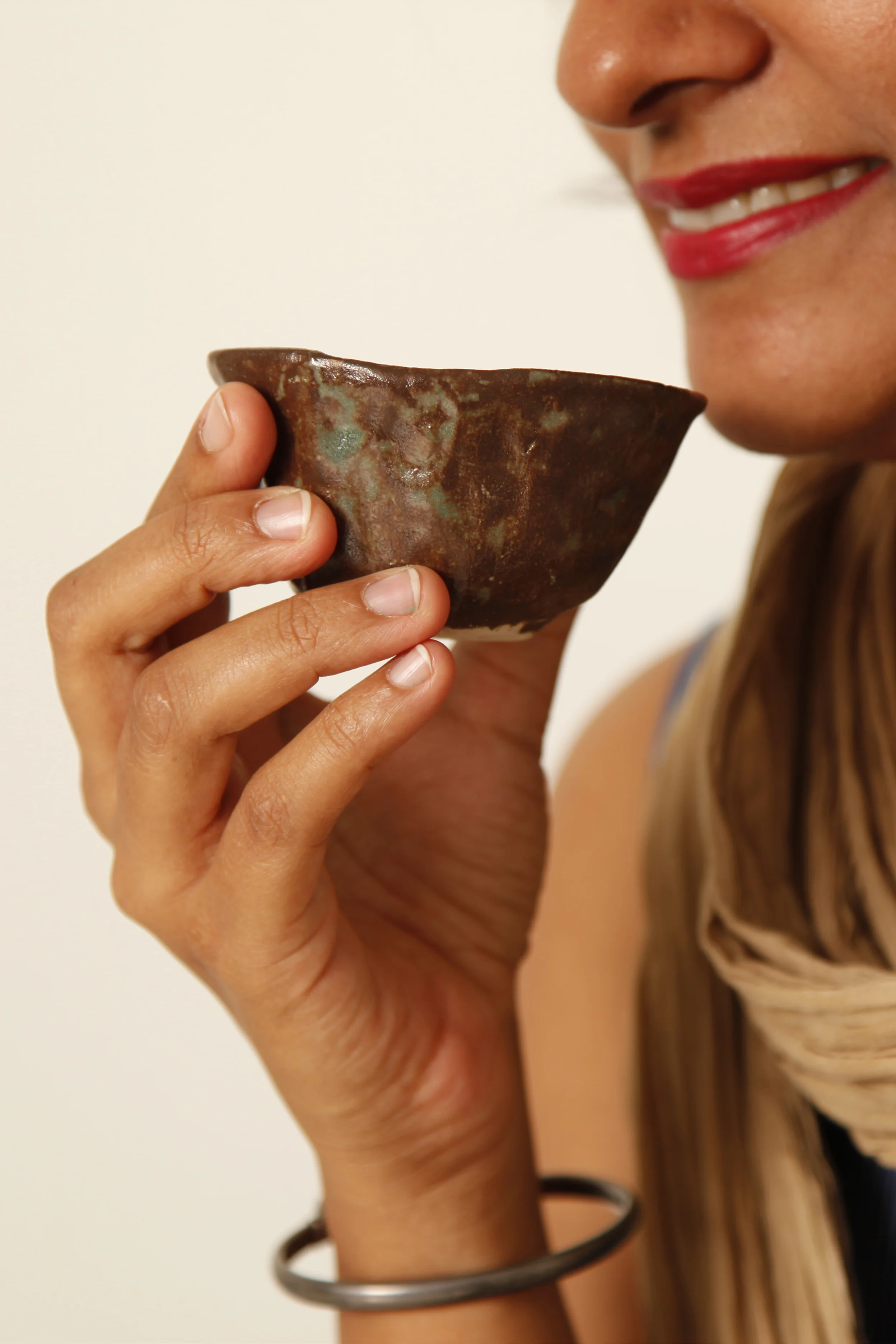 Woman holding a handmade clay cup